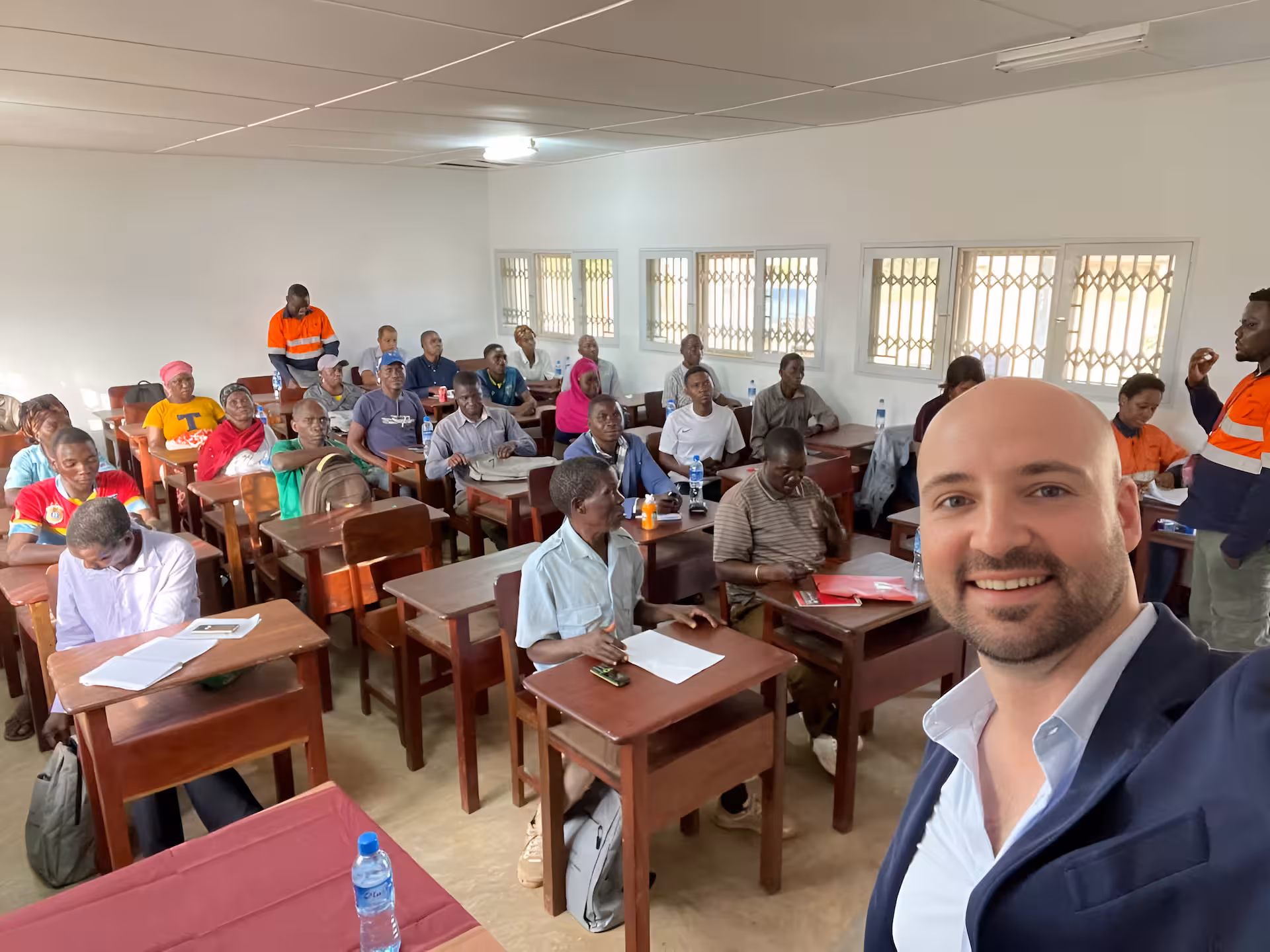 Thomas Gaultier with community members in the room before a mediation session in Mozambique
