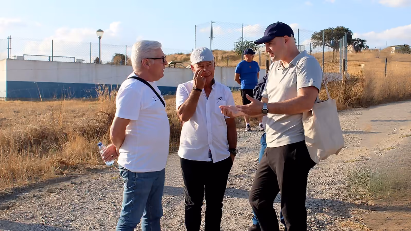 Thomas Gaultier in conversation with two residents on a track beside a project site