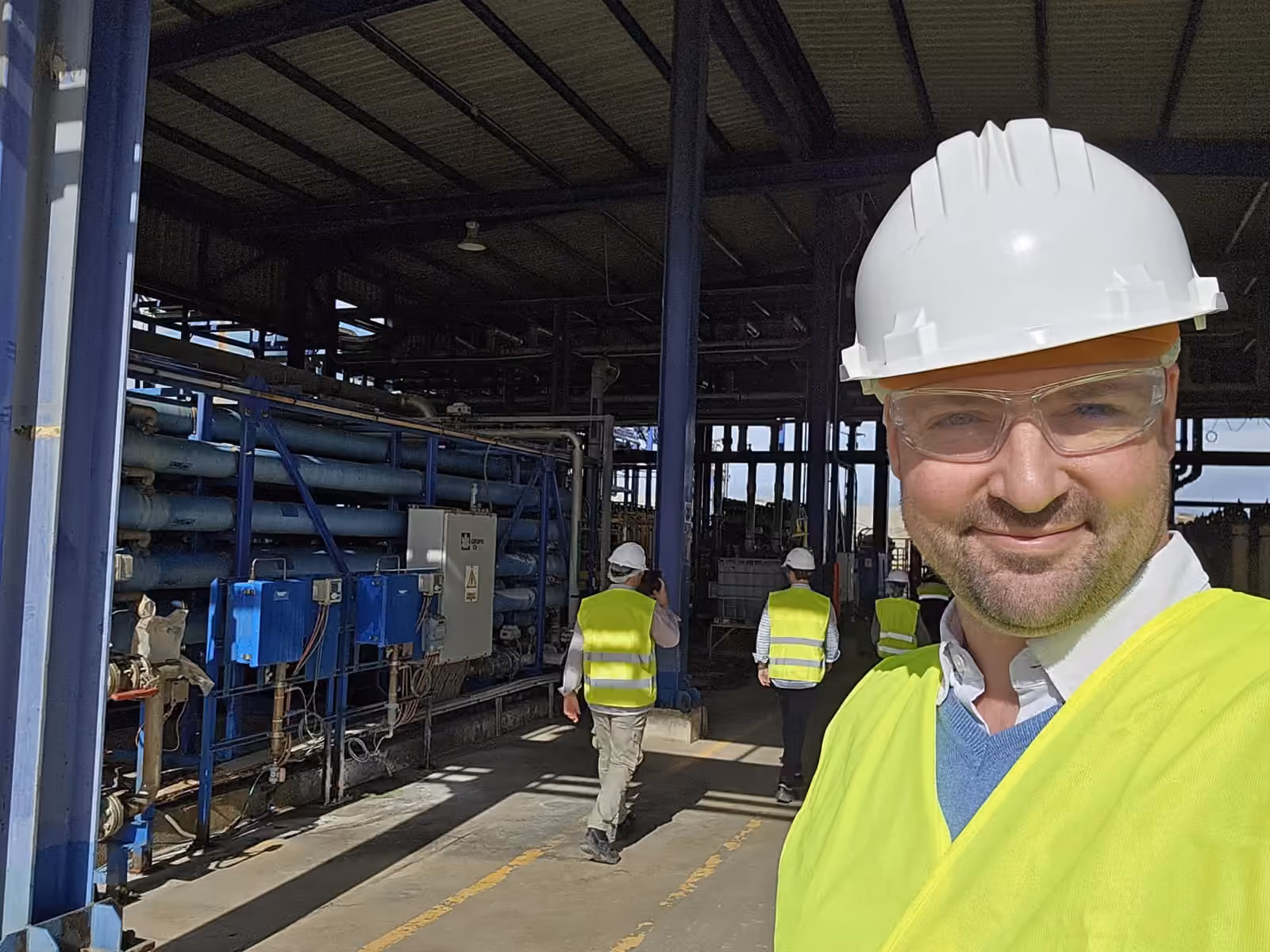 Thomas Gaultier in hard hat and high-visibility vest on a walkdown inside an operating plant